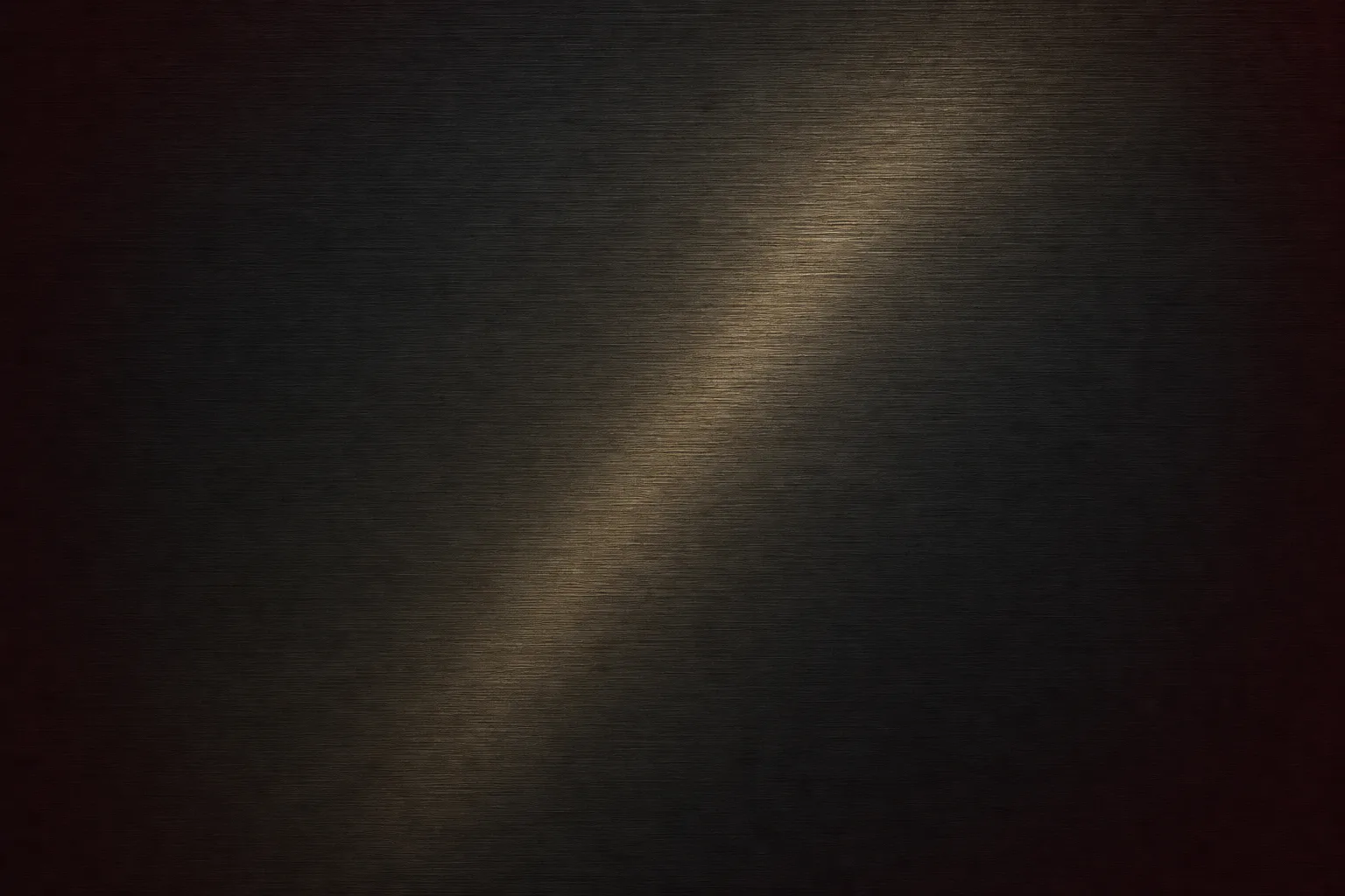 Close-up of dark brushed metal surface with warm brass-gold light sweep, representing material quality